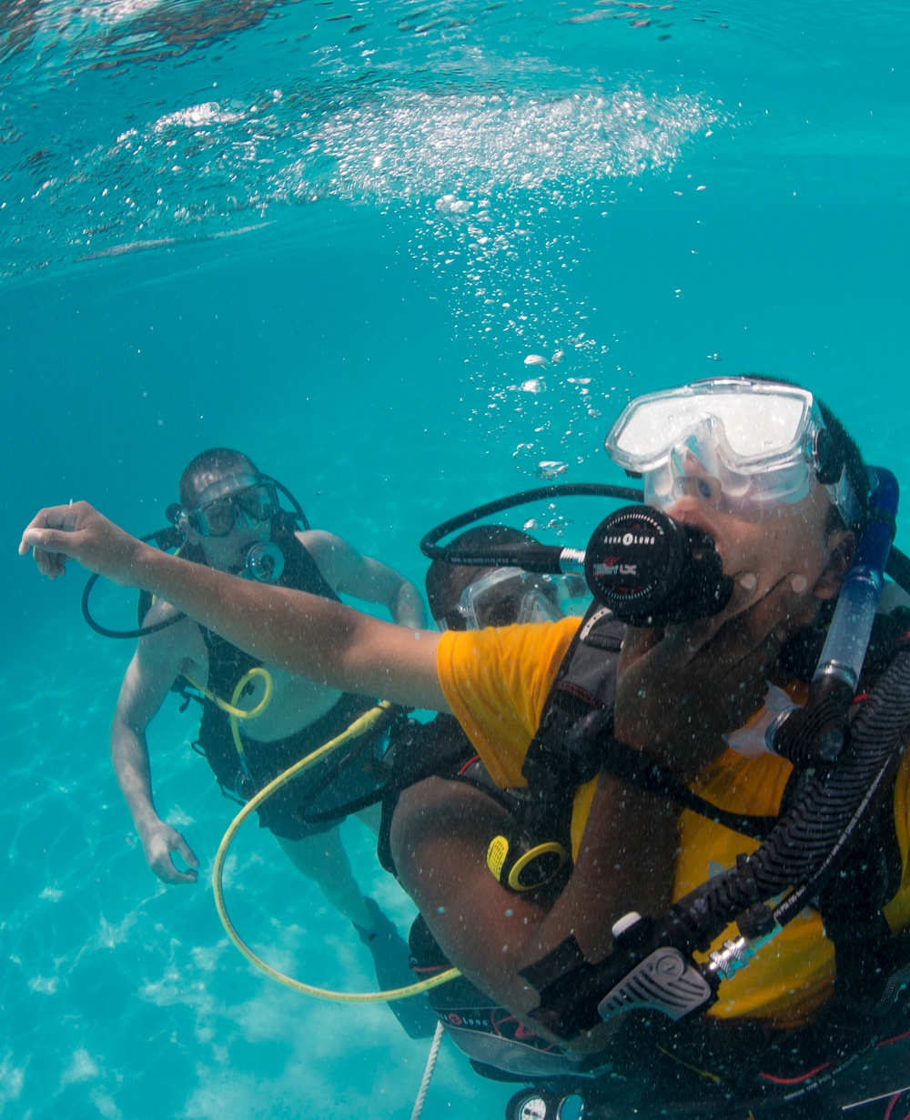 US Navy divers and Belizean Coast Guard divers practice SCUBA emergency procedures in a pool