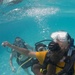 US Navy divers and Belizean Coast Guard divers practice SCUBA emergency procedures in a pool