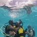 US Navy divers and Belizean coast guard divers practice SCUBA emergency procedures in a pool