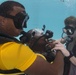 US Navy divers and Belizean coast guard divers practice SCUBA emergency procedures in a pool