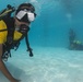 US Navy divers and Belizean coast guard divers practice SCUBA emergency procedures in a pool