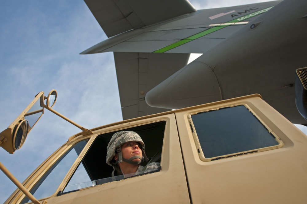 III Corps PFC backs LMTV into C-17