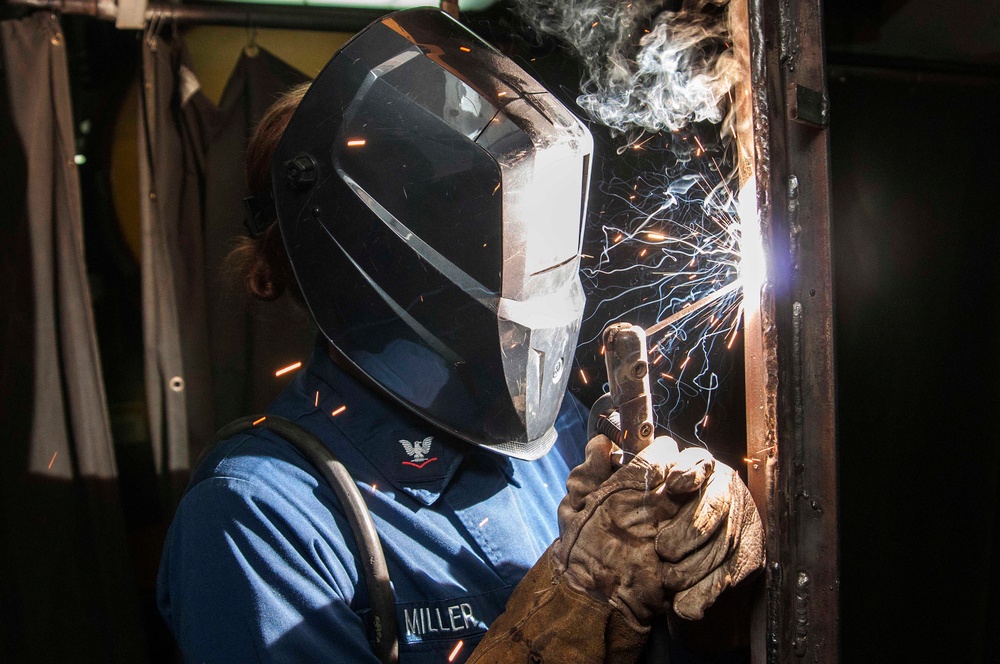 USS Dwight D. Eisenhower sailor practices vertical welding