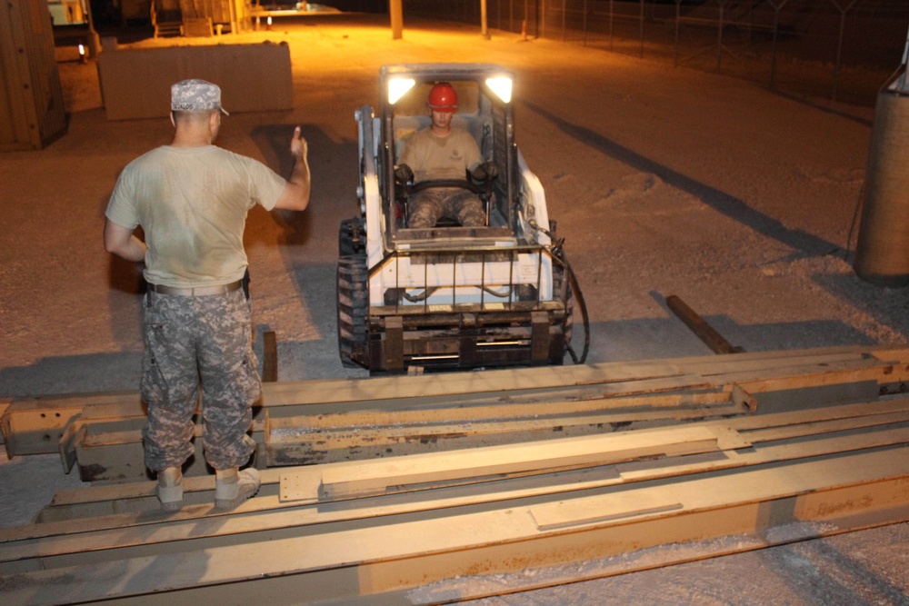 Soldiers from 40th ESB move pieces of equipment to prepare to set up new signal support equipment