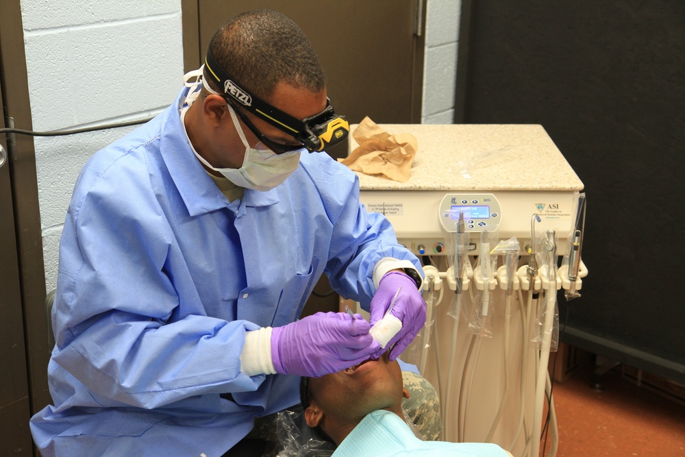 Dental hygienist sees patient during Southern Care 2014