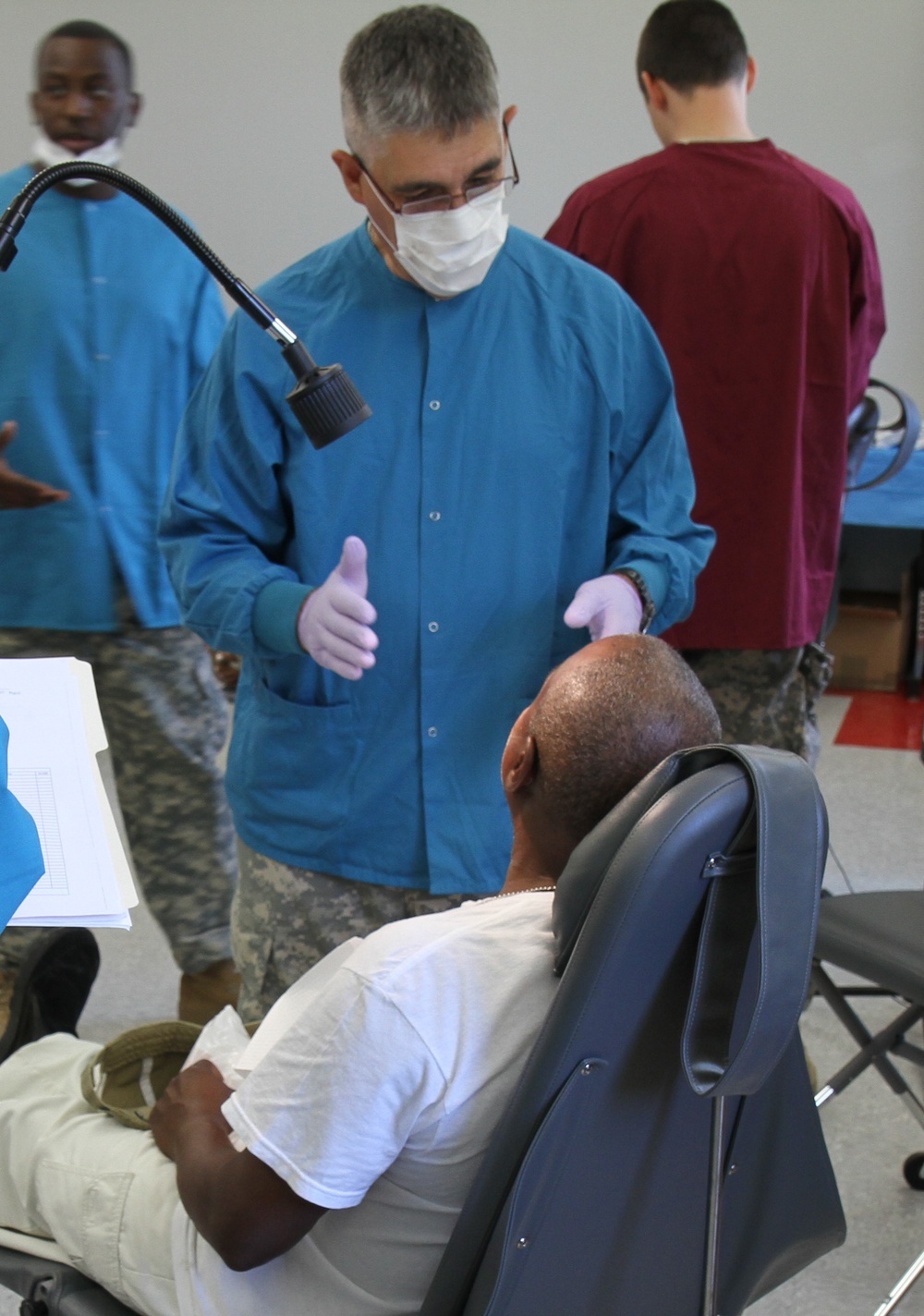 Dentist communicates dental health to civilian patient