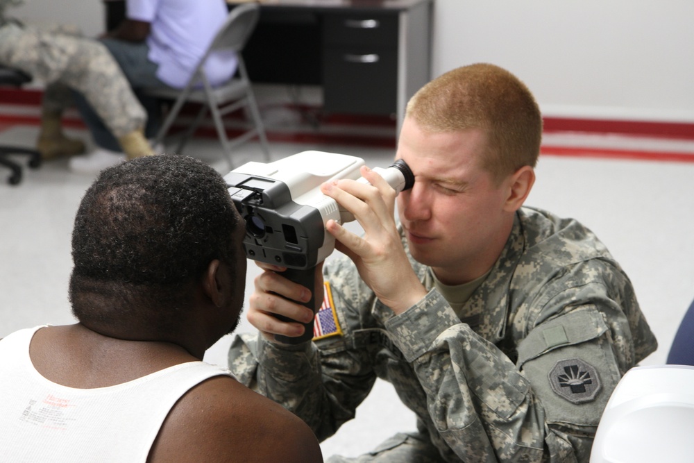 Optometry technician checks patient's eyes