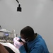Dental hygienist cleans a patient's teeth during Northern Louisiana Care 2014