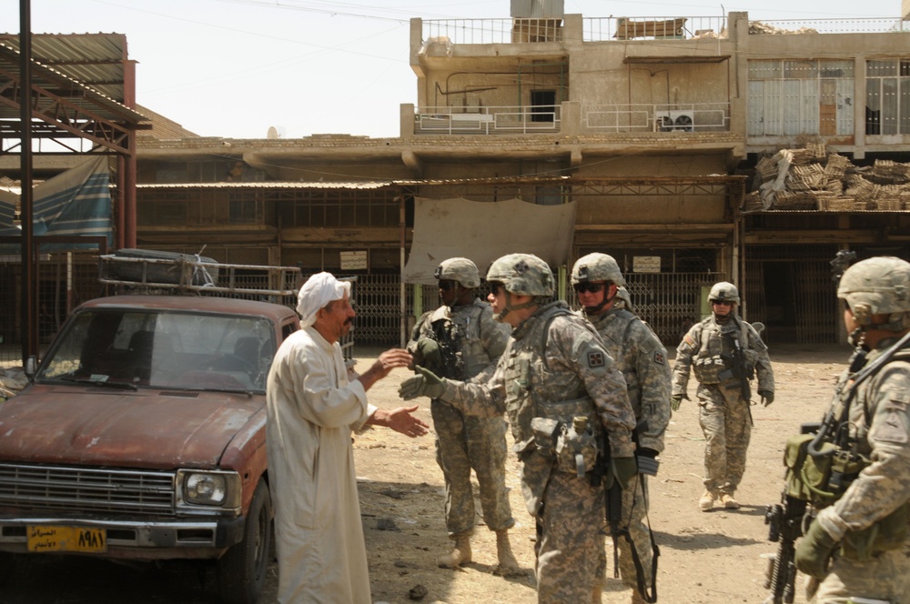 Gen. Jeffrey W. Talley speaks with business owner in Jameela Market
