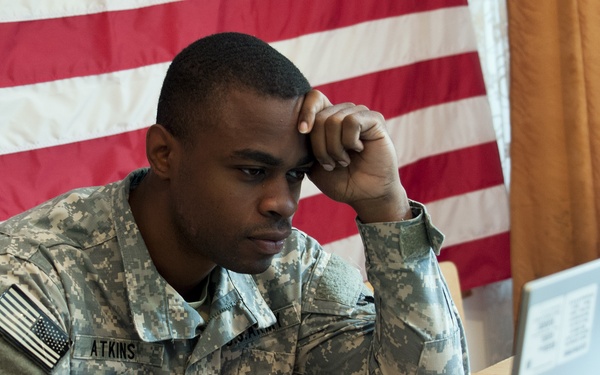 173rd Airborne Brigade paratrooper keeps paperwork moving in