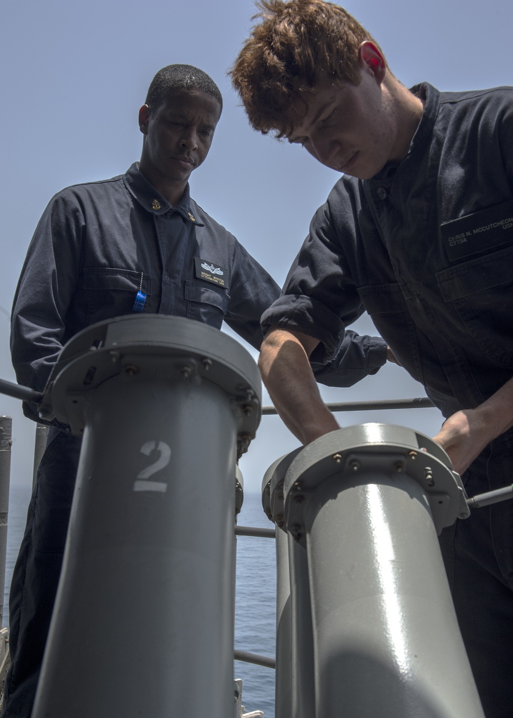 Sailors load anti-ship missile defense, chaff rounds