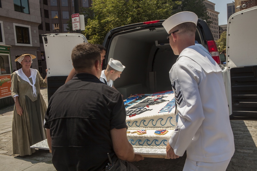 US Navy sailors help carry a cake during the opening ceremony for the annual Boston Harborfest