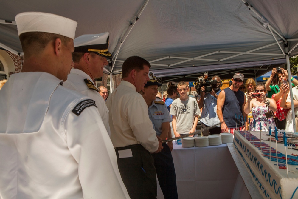 Boston's Mayor Marty Walsh cuts cake during opening ceremony of the annual Boston Harborfest