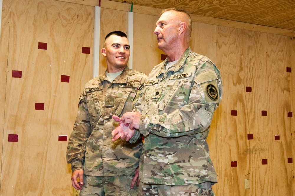 Father promotes son in combat zone, a rare opportunity