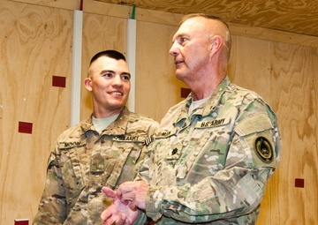 Father promotes son in combat zone, a rare opportunity