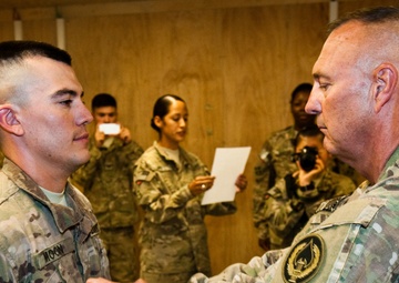 Father promotes son in combat zone, a rare opportunity