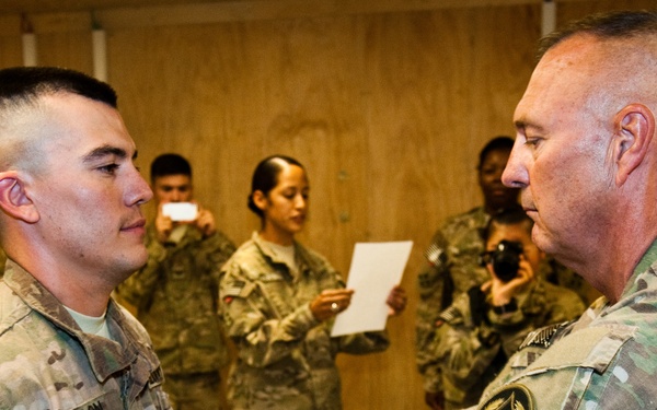 Father promotes son in combat zone, a rare opportunity