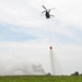 A CH-47 Chinook assigned to 2nd Battalion, 4th Aviation Regiment, 4th Combat Aviation Brigade, drops water on a simulated structure fire