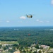 A CH-47 Chinook helicopter sling loads a Bambi Bucket over Muscatatuck Urban Training Center