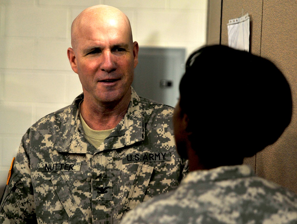 Col. Nutter visits with public affairs soldier in the Vibrant Response command center