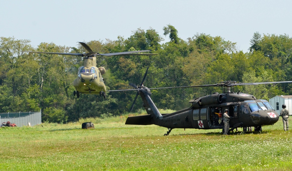 A CH-47 Chinook helicopter drops off simulated load of supplies