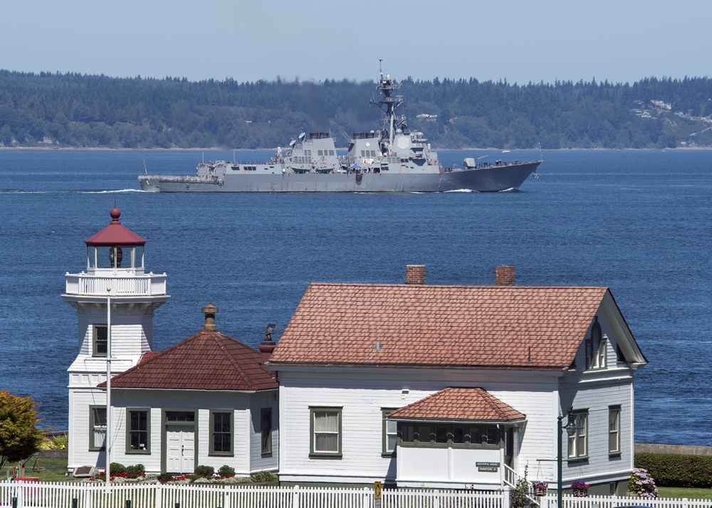 The Arleigh Burke-class destroyer USS Howard (DDG 83) passes the Mukilteo Lighthouse on her way to Naval Station Everett