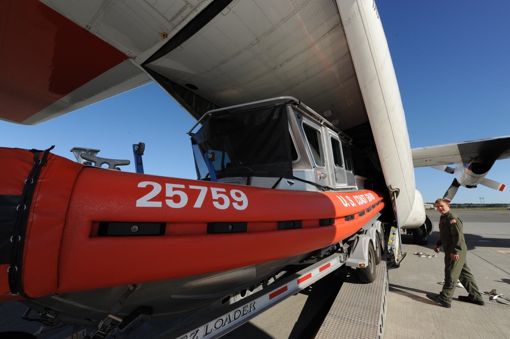 Coast Guard loads boat onto aircraft