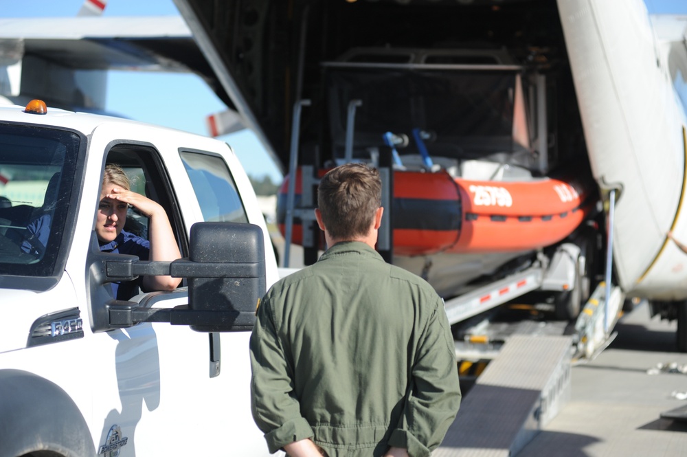 Coast Guard loads boat onto aircraft