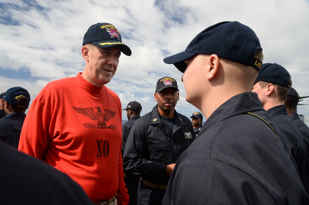 USS Makin Island Weapons Department Sailors receive uniform inspection