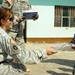 Soldier gives Iraqi boy school supplies