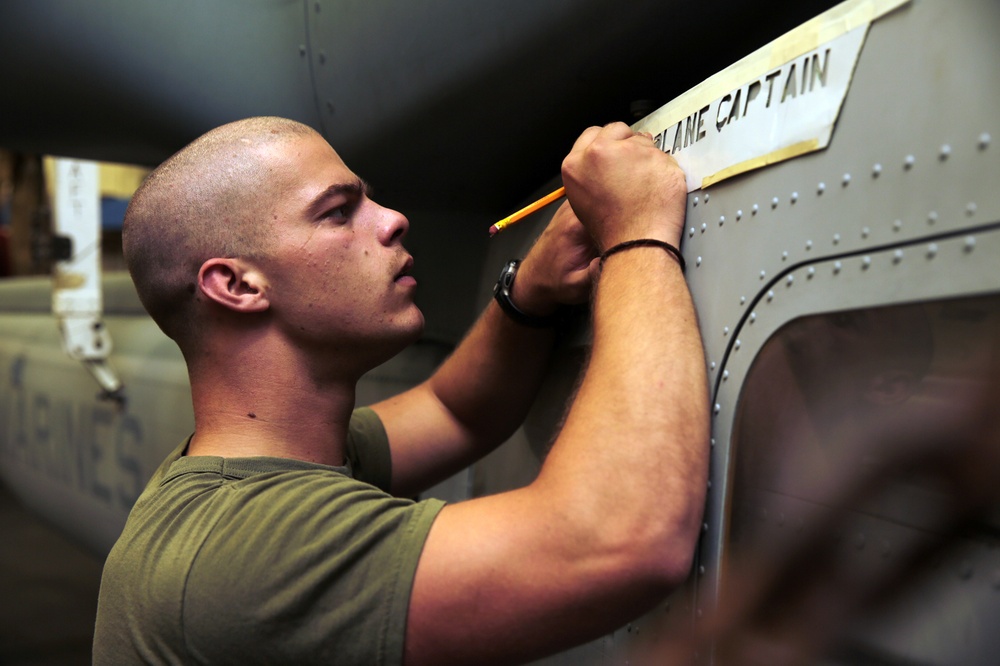 Marines and sailors perform maintenance underway