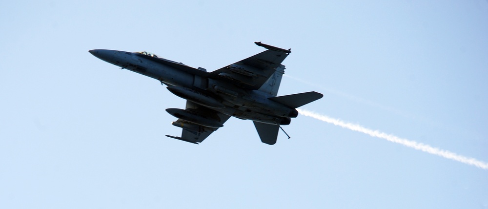 F/A-18C Hornet flies over USS George H.W. Bush