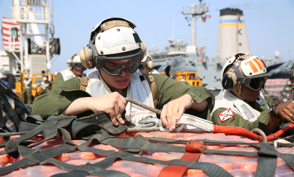 Marines move supplies during replenishment at sea