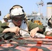 Marines move supplies during replenishment at sea