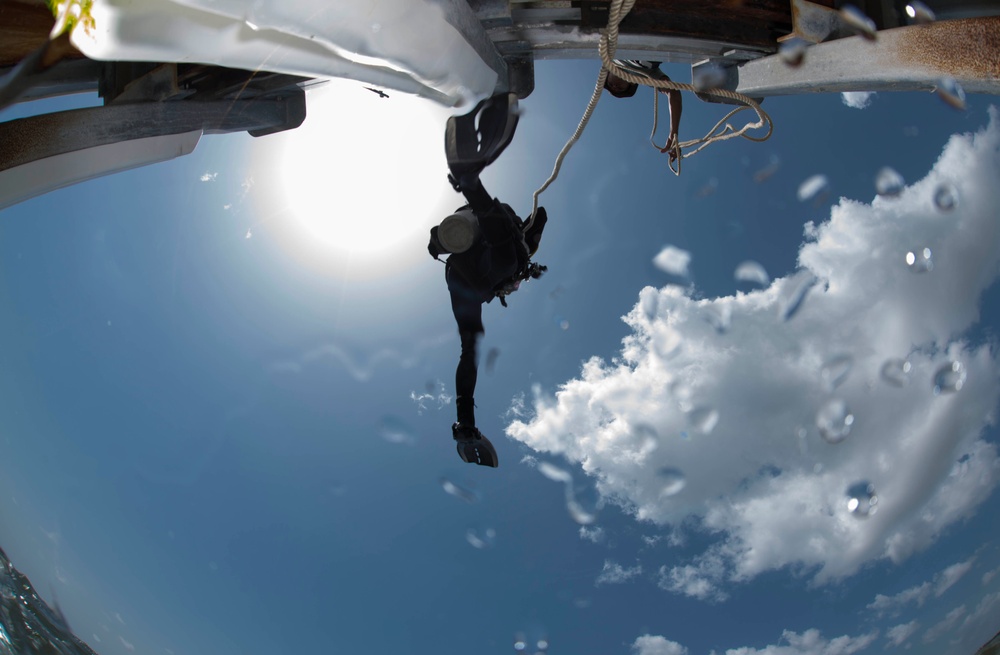 U.S. Navy diver steps off a pier during a joint dive with Guatemalan divers as part of Southern Partnership Station '14