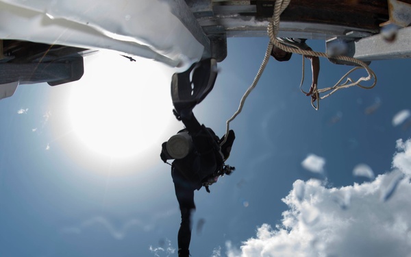 U.S. Navy diver steps off a pier during a joint dive with Guatemalan divers as part of Southern Partnership Station '14