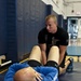 Master Sgt. Robert Scott instructs civilian Brad Yeomans and other members in the US Air Force's Delayed Entry Program on proper sit-up technique