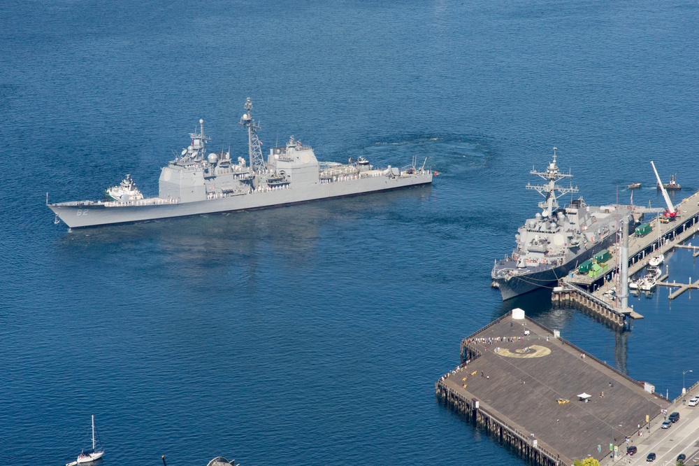 Sailors assigned to the Ticonderoga-class guided-missile cruiser USS Chancellorsville (CG 62) man the rails while departing Seattle's pier 66