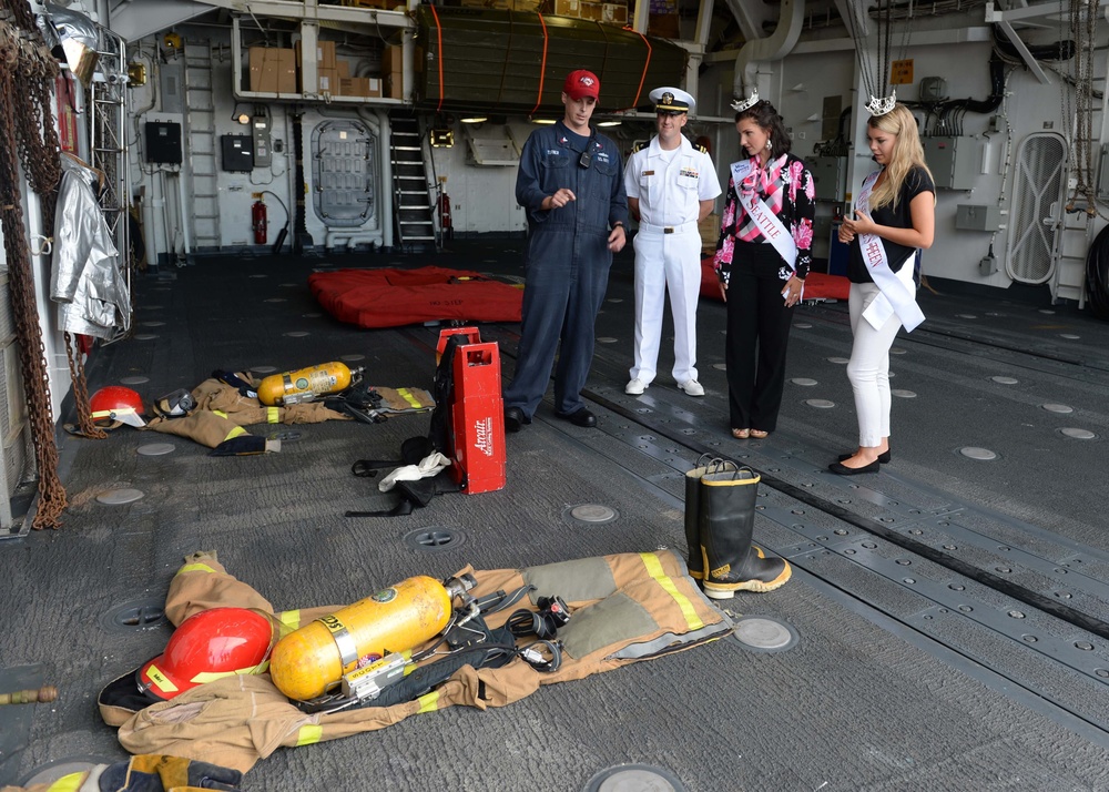 Kimball Gainor, Miss Seattle 2014, and Hailey Sturgill, Miss Seattle Outstanding Teen, are given a damage control tour by Damage Controlman 1st Class Ryan Turner