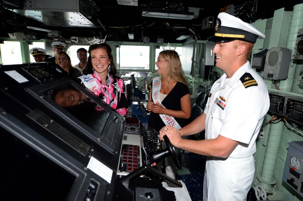 Kimball Gainor, Miss Seattle 2014, and Hailey Sturgill, Miss Seattle Outstanding Teen, are given a tour of the ship's bridge and helm by Lt. Zachary George