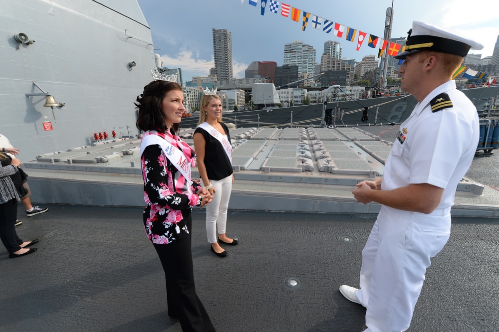 Kimball Gainor, Miss Seattle 2014, and Hailey Sturgill, Miss Seattle Outstanding Teen, are given a tour of the ship's forecastle by Lt. Zachary George