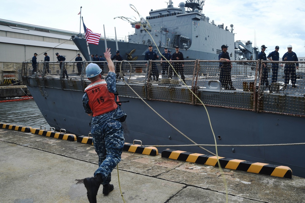 USS John S. McCain sailor throws mooring line