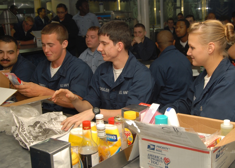 USS Carter Hall Sailors open holiday care packages