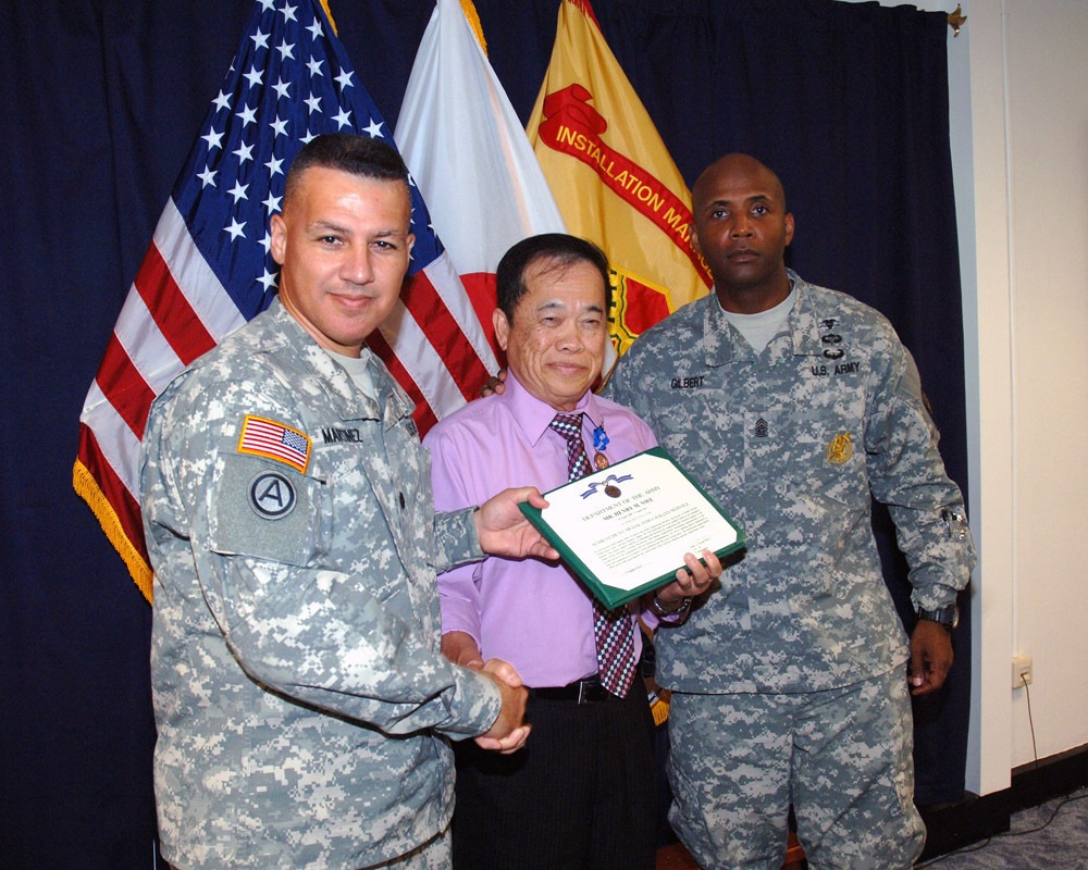 USAG-Okinawa Lt. Col. Eric Martinez hands out honors