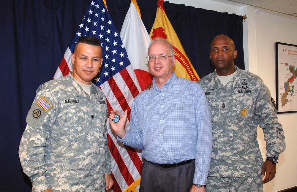 USAG-Okinawa Lt. Col. Eric Martinez hands out honors