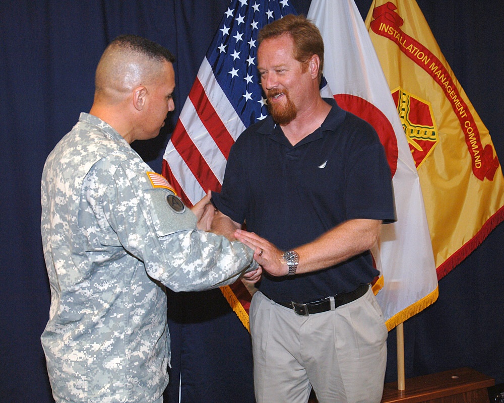 USAG-Okinawa Lt. Col. Eric Martinez hands out honors