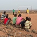 Djiboutian children watch service members play soccer