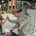 Soldier high-fives with local child at National Night Out