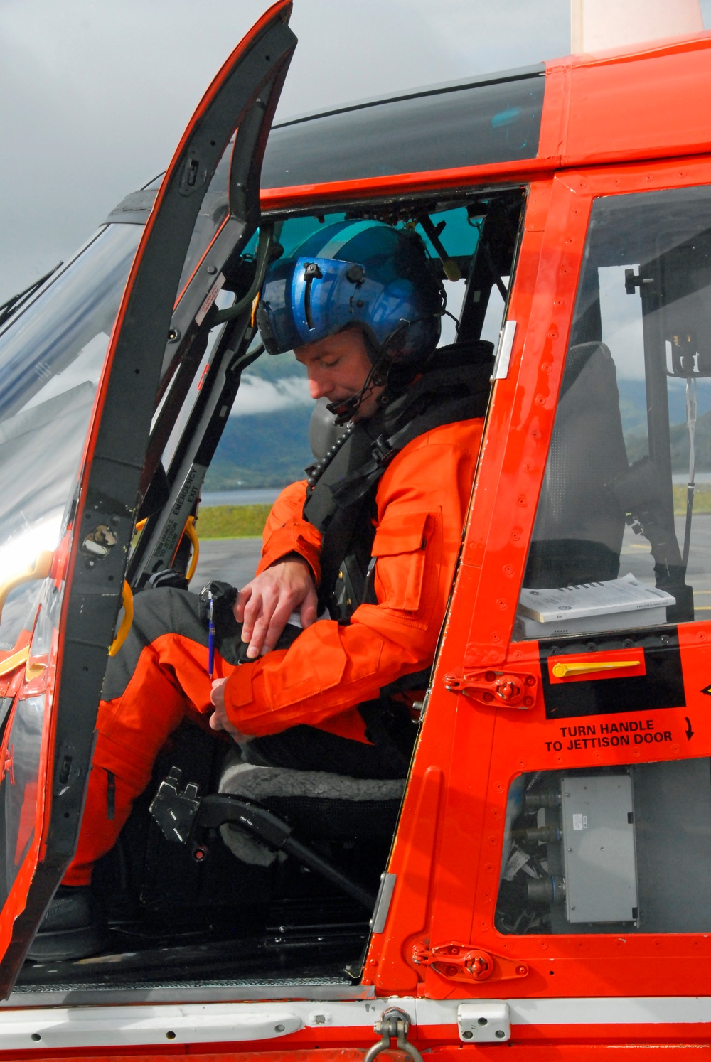 Coast Guard MH-65 Dolphin helicopter pilot prepares for takeoff in Kodiak, Alaska