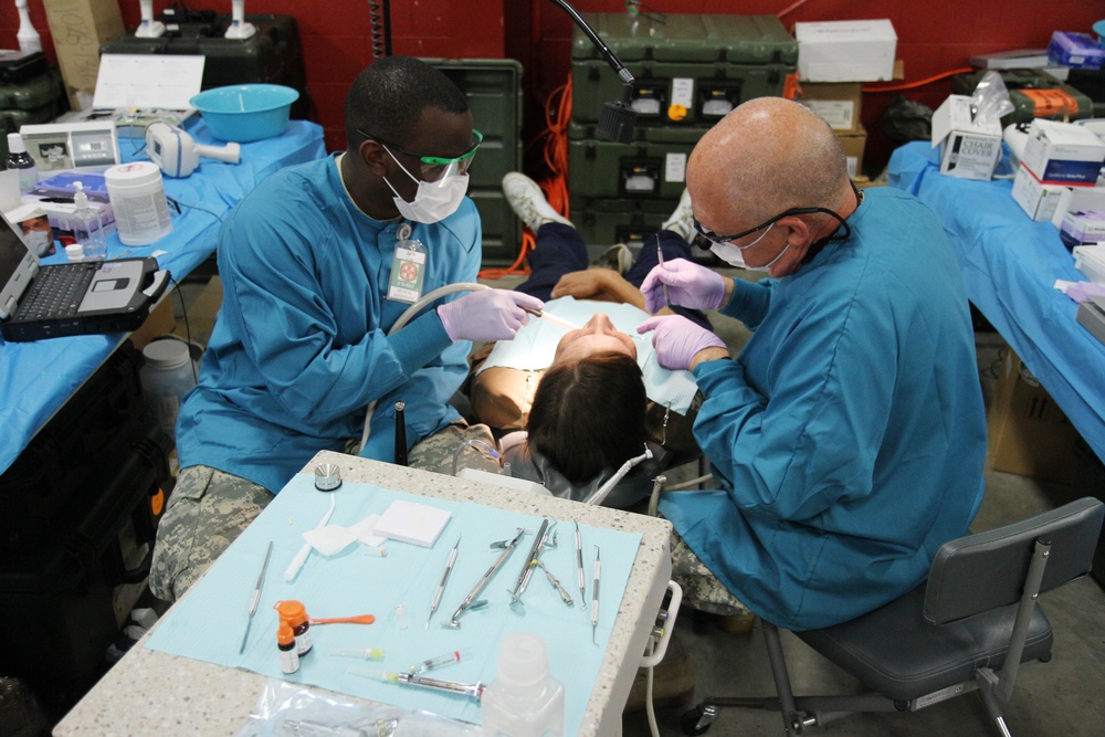Army dental professionals provide services to a local community member